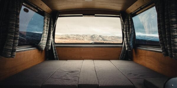 Comfortable and spacious camper van interior with scenic landscape view in Norway.