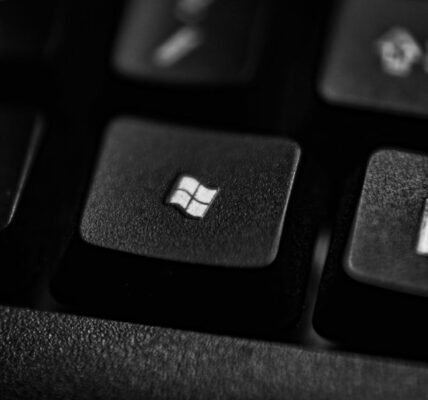 High-quality close-up of a Windows logo key on a black plastic keyboard.