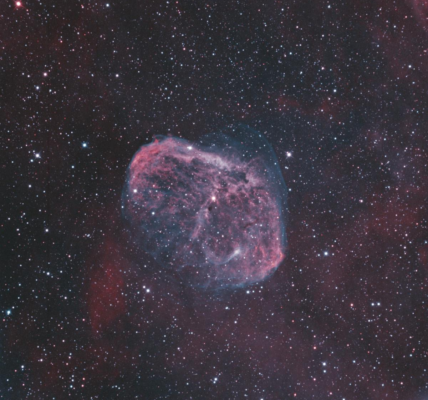 High-resolution image of Crescent Nebula (NGC 6888) with a vibrant cosmic background.