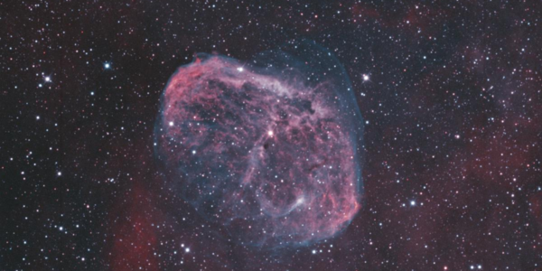 High-resolution image of Crescent Nebula (NGC 6888) with a vibrant cosmic background.