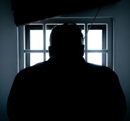 rear view of a silhouette man in window