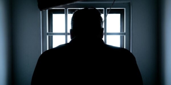 rear view of a silhouette man in window