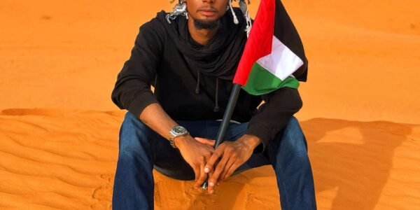 man in diffa desert holding palestinian flag