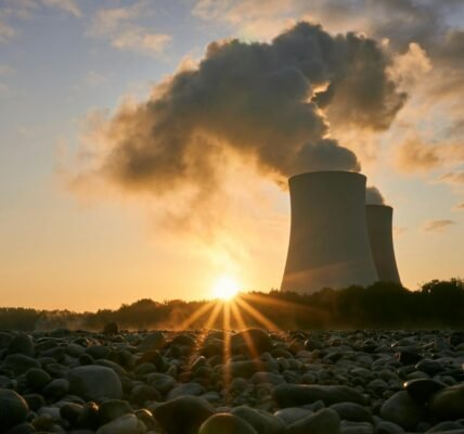 low angle photo of nuclear power plant buildings emtting smoke