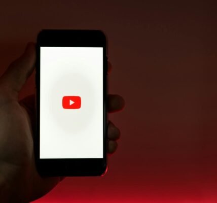 hand holding smartphone with internet access to youtube