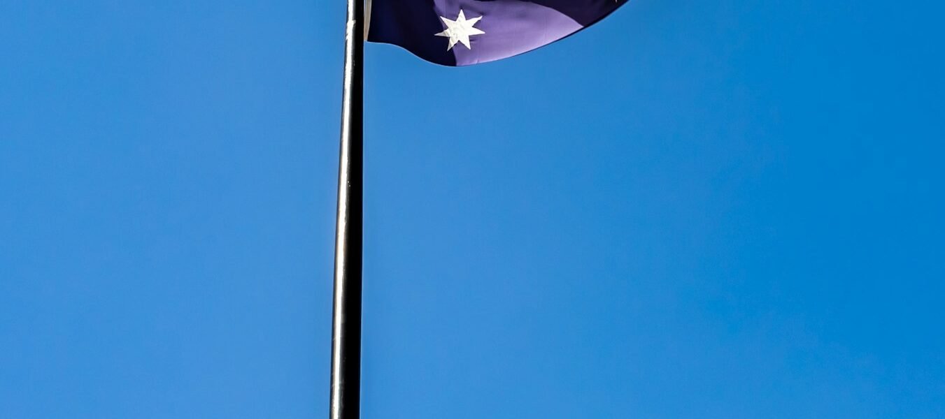 blue white and red flag under blue sky during daytime