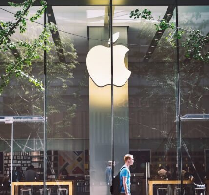 man passing an apple store