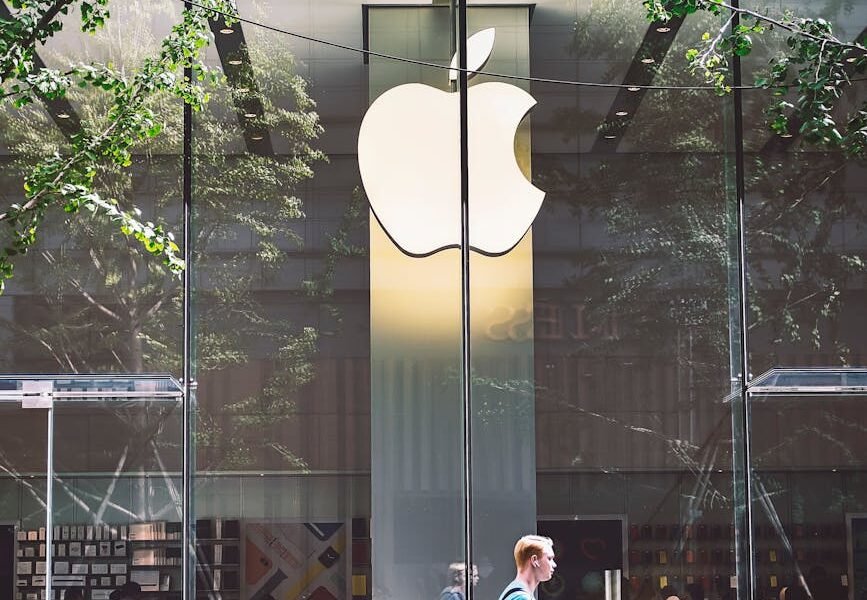 man passing an apple store