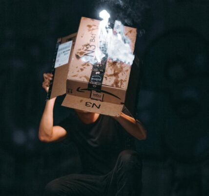 man raising cardboard box