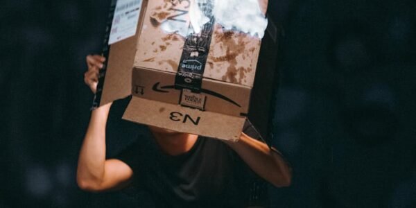 man raising cardboard box