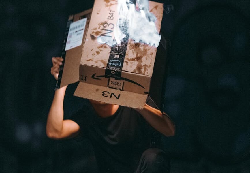 man raising cardboard box