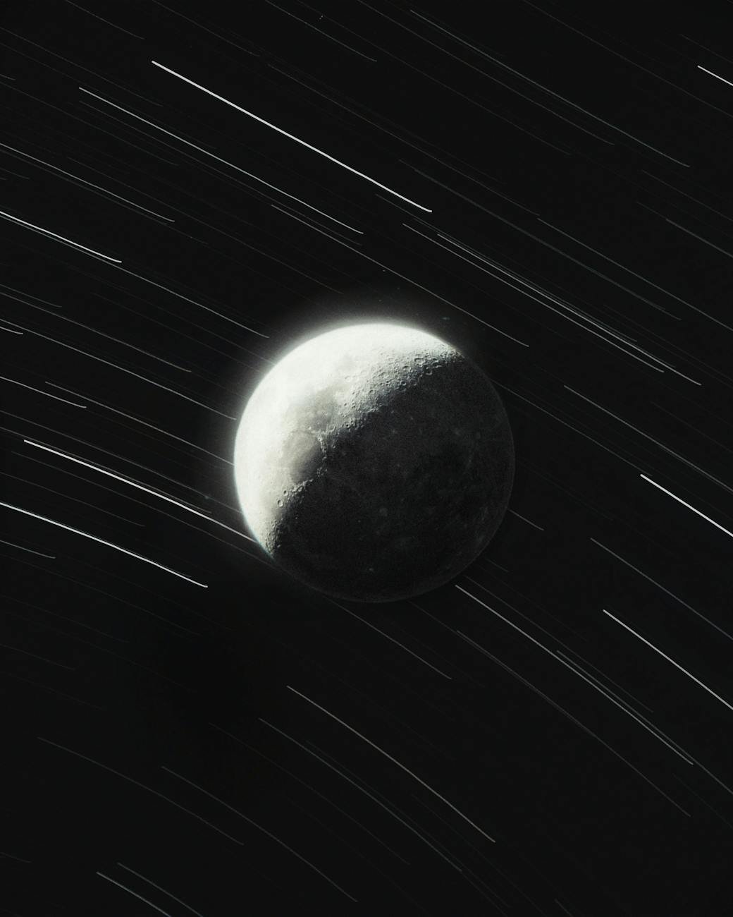 star trails with moon in night sky