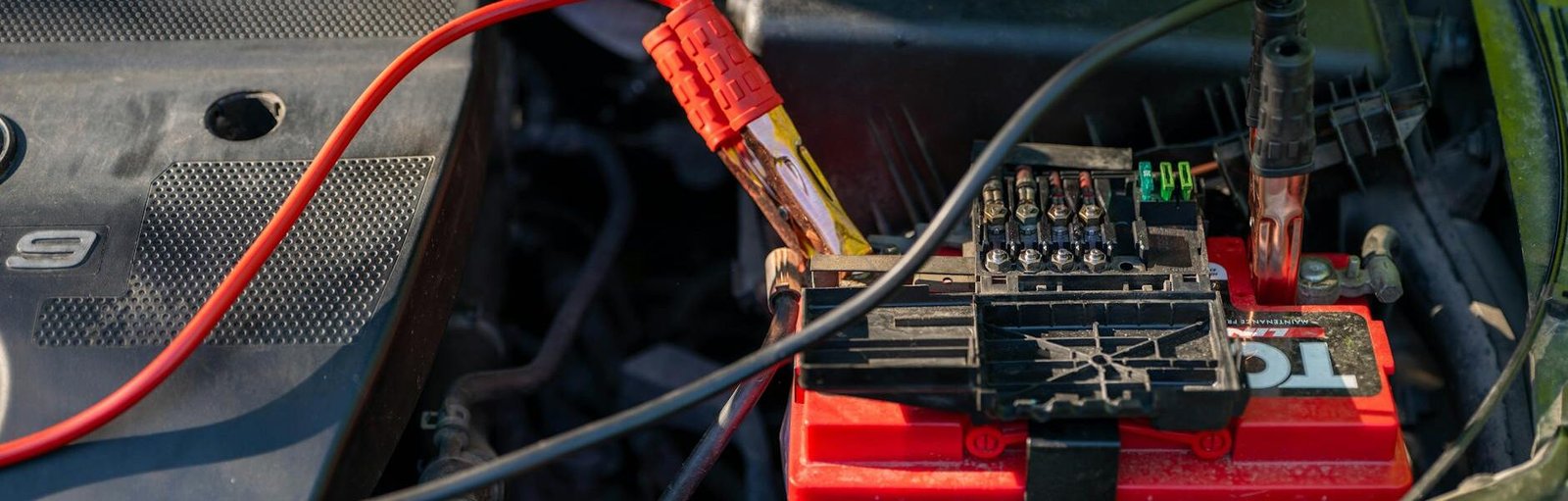 car battery with jumper cables attached