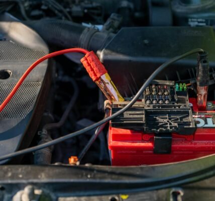 car battery with jumper cables attached