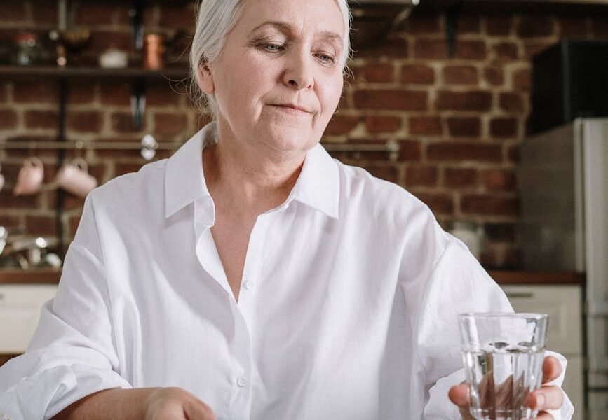 an elderly woman taking her medicines