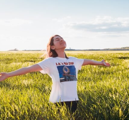 woman standing in green field
