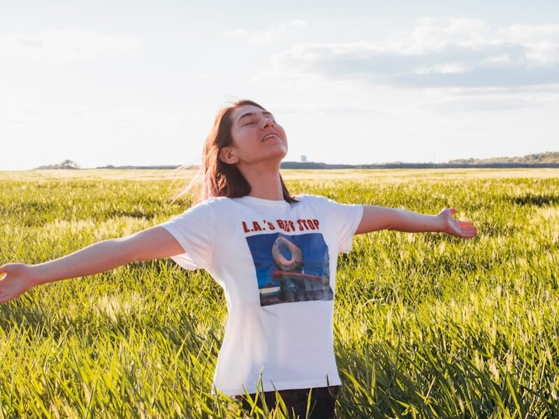 woman standing in green field