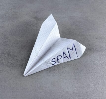 a paper airplane with the word spam written on it