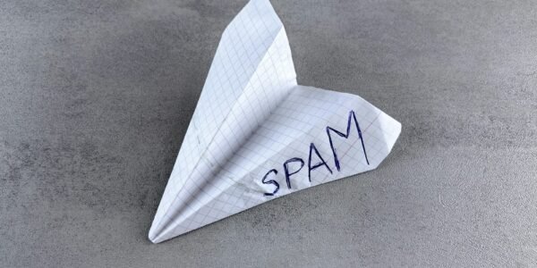 a paper airplane with the word spam written on it