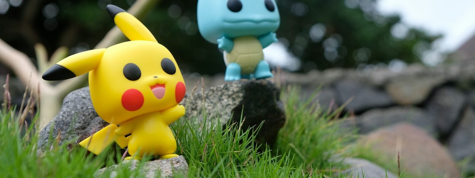 yellow and white duck plush toy on green grass during daytime