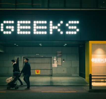 a couple of people that are walking in front of a building