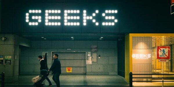 a couple of people that are walking in front of a building