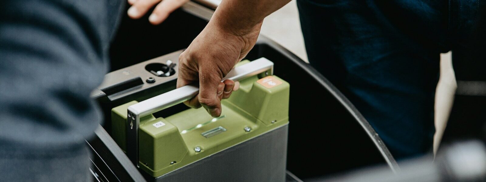 person holding black and green electronic device