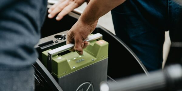 person holding black and green electronic device